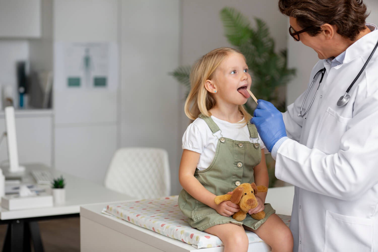 Doctor Examining a Child’s Throat