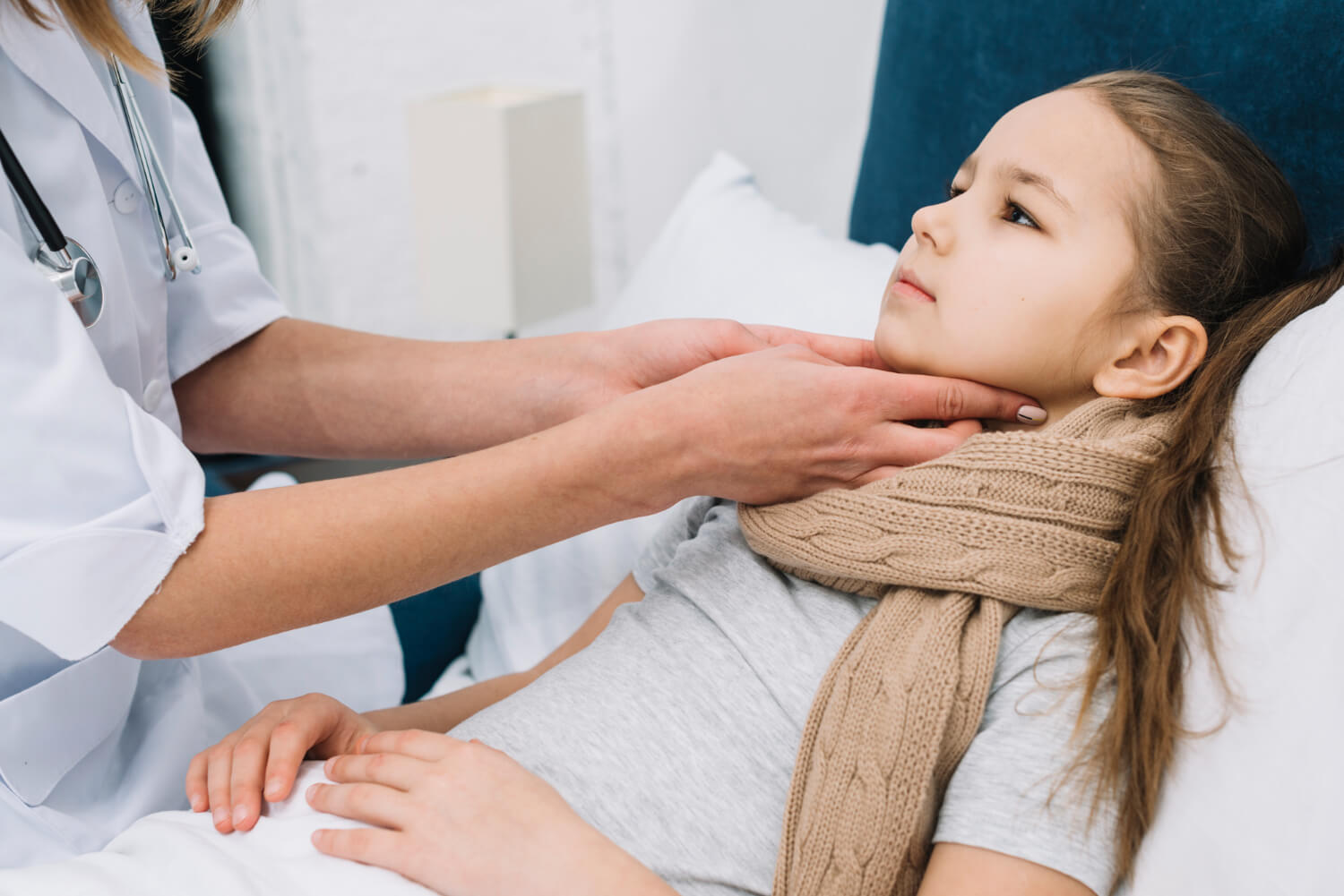 doctor hand checking the girl patient throat doctor hands checking a young patients throat