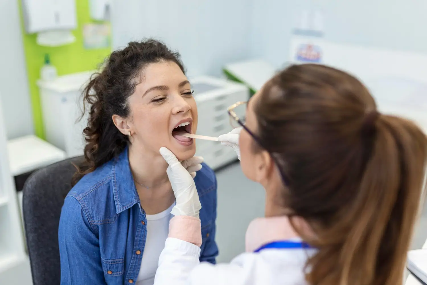 female patient opening her mouth doctor