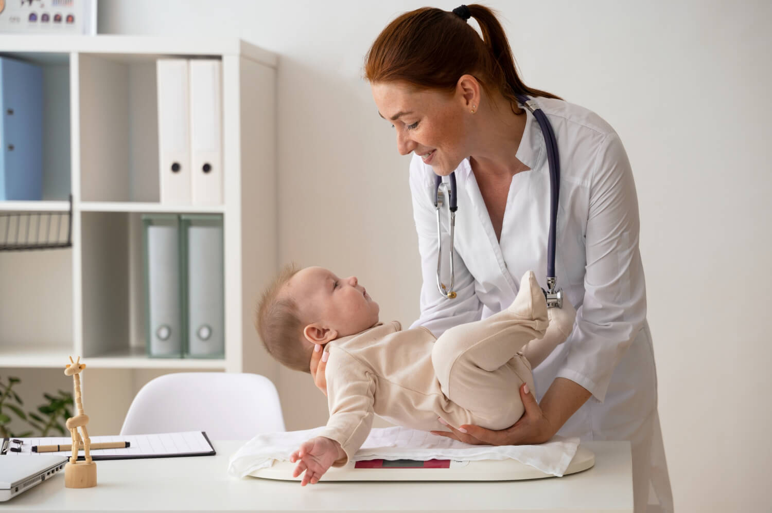 smiley doctor weighing babies pediatrician weighing a baby